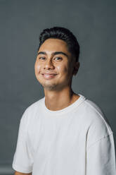 Smiling young man in studio - MEUF04325