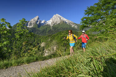 Mature male and female hikers walking on footpath during vacations - ANSF00030