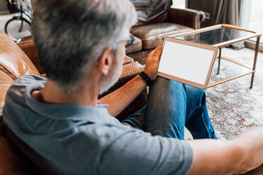 Italy, Businessman using digital tablet in creative studio - ISF25149