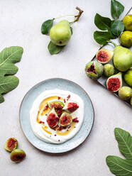 Top view plate of yogurt with figs on a table - ADSF31021