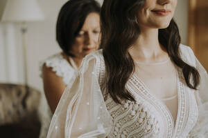 Smiling woman getting ready for wedding at home - SSGF00004