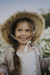 Smiling girl wearing flower in hair - SSGF00013