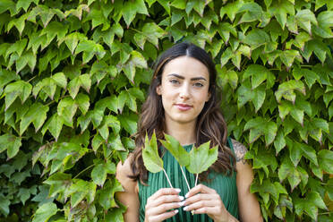 Young woman holding ivy leaves - EIF02206