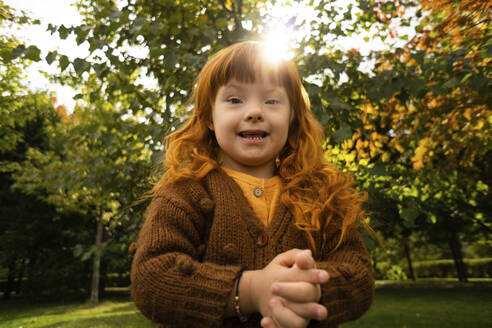 Smiling girl with down syndrome in park - SSGF00045