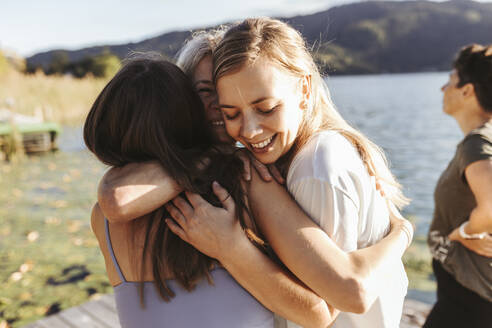 Female friends embracing each other after yoga class - DAWF02055