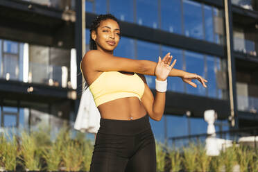 Full length of smiling athletic african-american sportswoman, wearing blue sport  outfit, stretching before fitness activity, workout over white Stock Photo  - Alamy