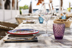 Empty glasses and plate on table at restaurant - DLTSF02321