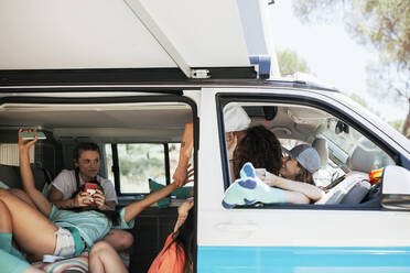 Female friends having fun in camper van - MRRF01626