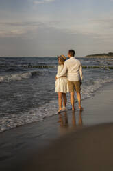 Young couple standing together at beach - SSGF00089