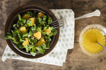 Plate of corn salad with pieces of orange - EVGF03921