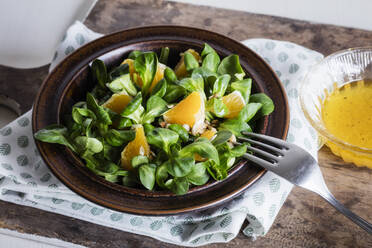 Plate of corn salad with pieces of orange - EVGF03922