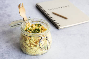 Jar of grated vegetable salad with note pad in background - EVGF03929