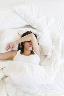 Young woman sleeping on bed at home - MRAF00680
