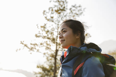 Hiker with backpack smiling - MRAF00708