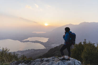 Backpacker looking at sunset - MRAF00731