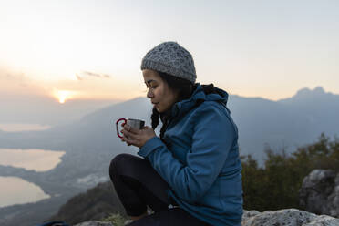 Woman having coffee on mountain - MRAF00739