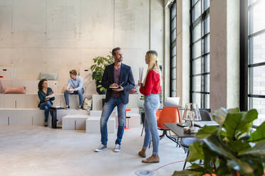 Businessman having discussion with coworker in office - DIGF16597