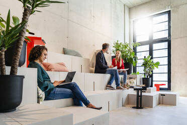 Businesswoman using laptop at coworking office - DIGF16634