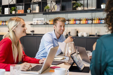 Employees attending meeting in coworking office - DIGF16639