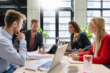 Employees planning strategy in meeting at office - DIGF16651