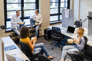 Employees having food at coworking office - DIGF16698