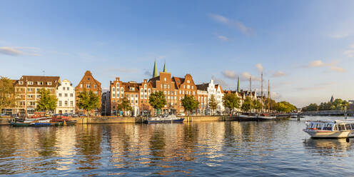 Germany, Schleswig-Holstein, Lubeck, Panoramic view of river Trave canal with historic townhouses in background - WDF06650