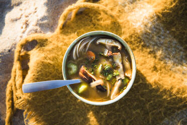 Vertical shot of soup while beach car camping - CAVF94968
