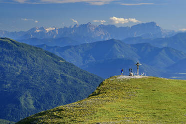 Woman standing at mountain edge in Carinthia, Austria - ANSF00056