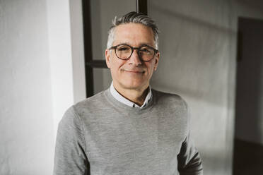 Portrait of smiling male entrepreneur wearing eyeglasses - MASF26589