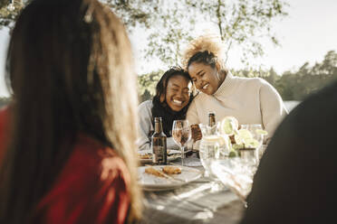 Happy young female friends in party during sunny day - MASF26797