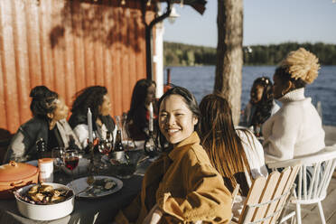 Portrait of smiling woman with female friends in party on sunny day - MASF26804