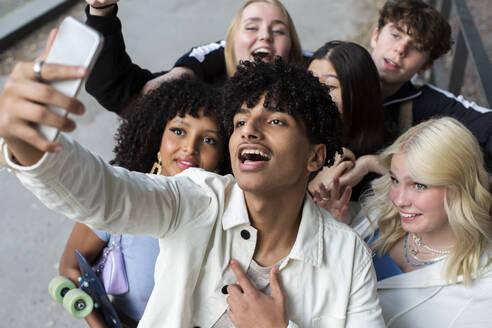 Männliche und weibliche Freunde nehmen Selfie durch Smartphone auf der Straße - MASF26853