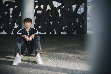Portrait of teenage boy in parking garage - MASF26894