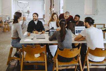 Computer programmers discussing in meeting at startup company - MASF27110