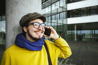 Smiling student talking on mobile phone at campus - IHF00588