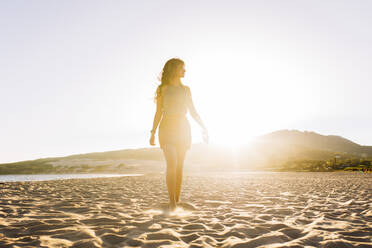 Young woman walking on sand at beach - EGHF00212