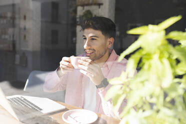 Businessman having coffee at cafe table - JCCMF04456