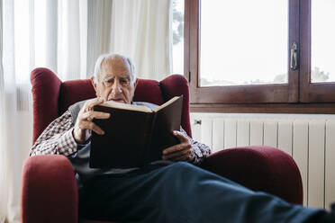 Senior man reading bible at home - JRFF05197