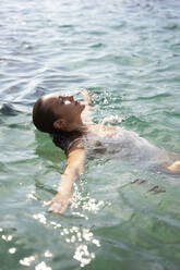 Woman swimming in sea on weekend - VEGF05170