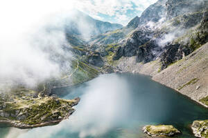 Aerial view of the Lac du Crozet with fog, lake nestled between mountains peak, Massif de belledonne, Grenoble, Isere, Rhone-Alpes, France. - AAEF13292