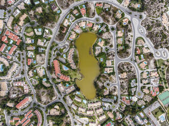 Aerial view of an exclusive luxury village with expensive villas and hotels on Troia Peninsula along the beach with artificial lake, Setubal, Portugal. - AAEF13304