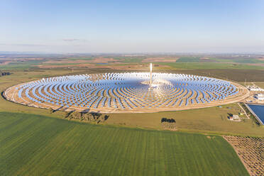 Aerial view of a Gemasolar Thermosolar Plant with a molten salt heat storage system located within the city limits of Fuentes de Andalucía in the province of Seville, Spain. - AAEF13309