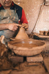 Potter making earthenware in pottery - GRCF01020