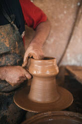 Potter making pot in workshop - GRCF01022