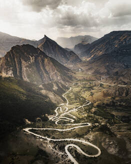 Aerial view of a zig zag road crossing a mountain valley near Korodinsky, Republic of Dagestan, Russia. - AAEF13401