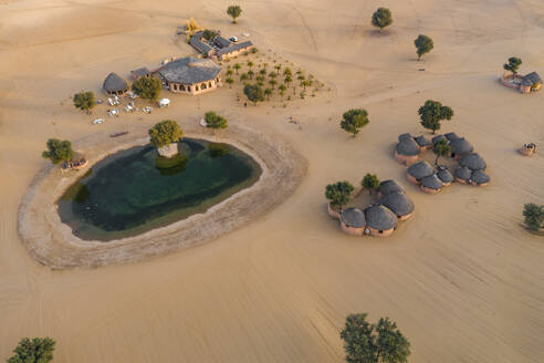 Aerial view of Khimsar Sand Dunes Village, a luxury resort in the desert, Kheenvsar, India. - AAEF13407