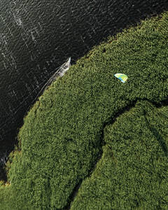 Luftaufnahme eines Kiteboarders beim Surfen in einer wilden Naturlandschaft in Klaipėda, Svencele, Litauen. - AAEF13421