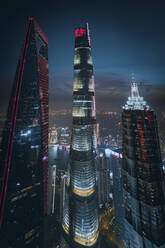 Aerial view of WFC, Shanghai Tower and Jin Mao building in Shanghai at night, China. - AAEF13470