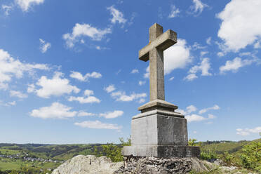 Summit Cross on rock under sky in Simmerath, Eifel, North Rhine Westphalia, Germany - GWF07263