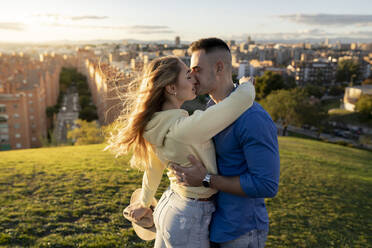 Young Couple kissing each other at sunset - JCCMF04510